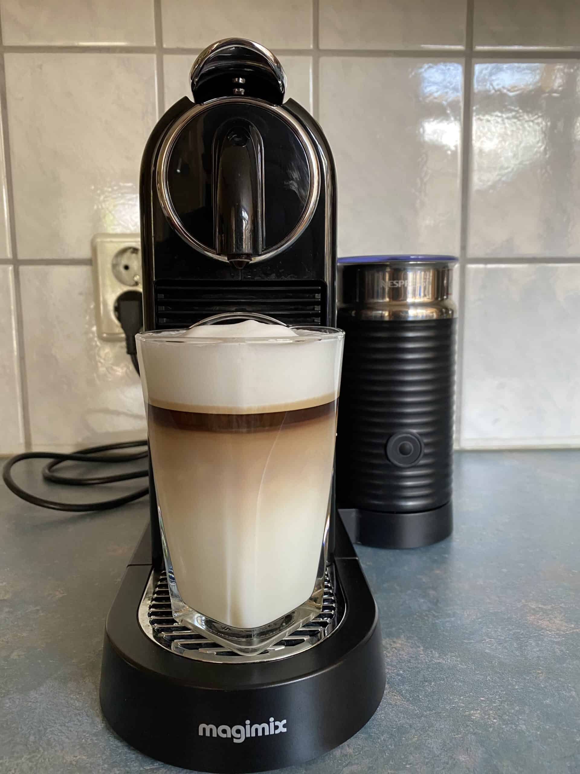 Nespresso machine making latte.