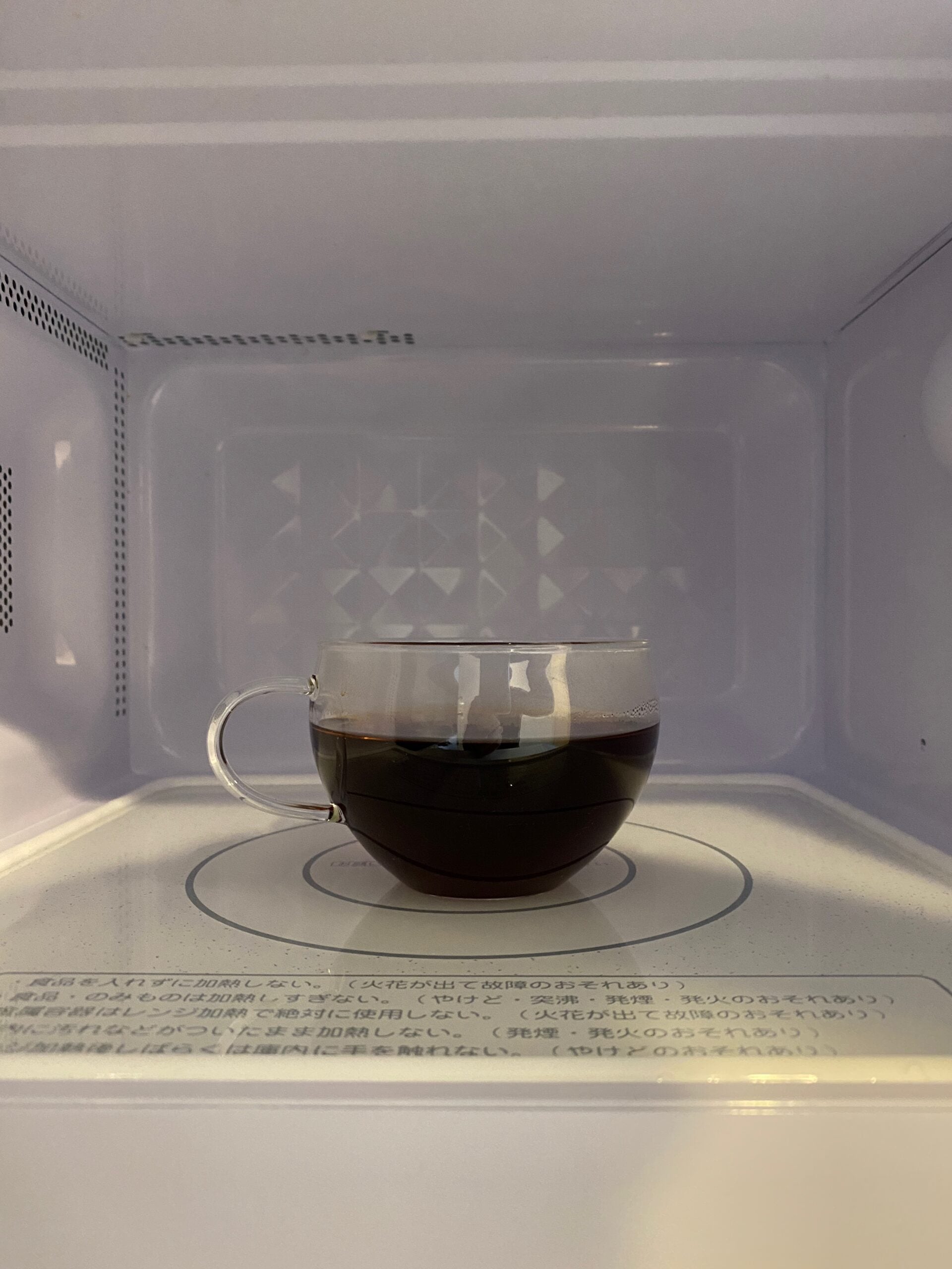 Reheating brewed coffee in a microwave.