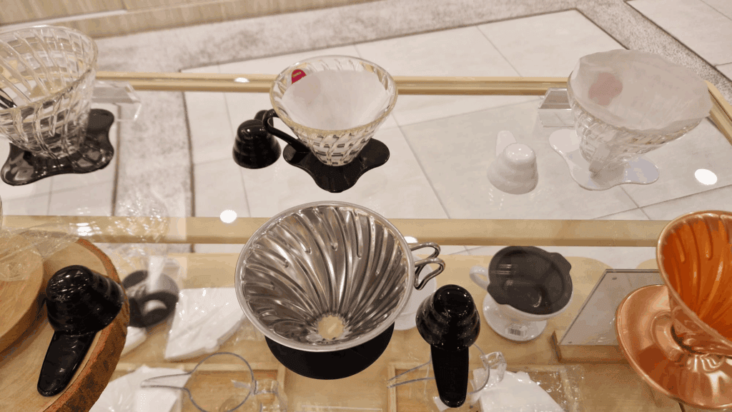 Different Hario V60 models with fitting coffee filters in them.
